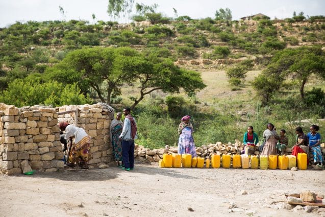 Families wait to fetch water from a UNICEF supported water point in Kihen village, Kilte Awlalo Woreda.   UNICEF has provided financial support to alleviate the critical shortage of water supply in the woreda for the drilling of 5 shallow wells (Kihen village is one of them), provision of 11,000 water treatment chemicals and deployment of one water truck. As a result, about 5,300 people have access and use to potable water supply in the Woreda.   The drilled water well in Kihen village is managed by Water and Sanitation Committee, who are elected by the beneficiaries and composed of 6 female. The beneficiaries contribute ETB 10 (less than 0.5US$ cents) per month per household for operation and maintenance of the water supply scheme (water well fitted with hand pump). The water well is drilled in January 2016. Since then, it is serving about 261 people (145 female, 116 male).  Japan media members led by the Japan Center for International Exchange visit UNICEF programmes in Tigray Ethiopia.  Due to the effect of El Nino driven shortage of rainfall, Tigray Region has been affected by severe shortage of drinking water for both people and livestock. The effect was manifested through declining of groundwater levels, drying of water wells and increased malfunctioning of water supply schemes. The main water supply sources for domestic consumption is groundwater source, which is subject to fluctuation of rainfall.  Kilte Awlalo Woreda is one of the 20 woredas, which is affected by the current El Niño induced drought phenomenon. ©UNICEF Ethiopia/2016/Sewunet Japan media members led by the Japan Centre for International Exchange visit UNICEF programmes in Tigray Ethiopia.  Due to the effect of El Nino driven shortage of rainfall, Tigray Region has been affected by severe shortage of drinking water for both people and livestock. The effect was manifested through declining of groundwater levels, drying of water wells and increased malfunctioning of water supply schemes