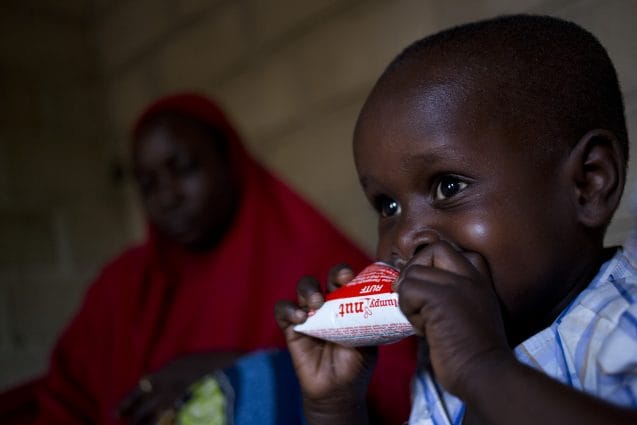 Internally displaced Alagi Dubji  son Oumar (3 and a half) eat a peanut butter supplement, at their home in Maroua in Northern Cameroon, Monday 4 April 2016. Oumar walked for 5 kilometres to look for help when their house was attacked . Alagi and his family had to flee from his village near Maroua after Boko Haram fighters burned down his house.Alagi had 40 children with 26 still alive.The conflict in North-East Nigeria prompted by Boko Haram has led to widespread displacement, violations of international humanitarian and human rights law, protection risks and a severe humanitarian crisis. This is one of the fastest growing displacement crisis in Africa  one of the worlds most forgotten emergencies, with little attention from the donor community. Across Nigeria, Niger, Cameroon and Chad, over 2.7 million people  mostly women and children  have now fled the Boko Haram-related violence. Many children have been subject to grave violations including forced recruitment, and being used as suicide bombers. Women and girls have been trafficked, raped, abducted and forcibly married. Schools have been attacked, looted, damaged or used as shelter by displaced families. The conflict is exacting a heavy toll on children, affecting not just their well-being and their safety but also their access to basic health, education, nutrition and social services.