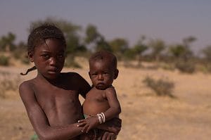Location: Cahama, Cunene Province, Angola Guilhermina, 8, and her sister, Lucia Segunda, join their mother at a mostly dry borehole in the Cunene Province of Angola. The girls live in an area of Angola that has been particularly hard hit by the recurrent cycles of droughts and floods that characterize El Nino. This has seriously affected food supply and rates of malnutrition have doubled over the last six months. Baby Lucia has just been identified as at risk of malnutrition. A tape used to measure a childs upper arm circumference (MUAC) put her in the yellow zone. The girls mother, Monica Vesse Vesse, works on a farm as a day labourer but with crops failing and inflation rising, their condition is perilous. Gifts to UNICEF help us respond to one of the strongest El Nino events ever recorded, placing the lives of 26.5 million children at risk of malnutrition, water shortages and diseases in Angola and nine other countries in Eastern and Southern Africa.