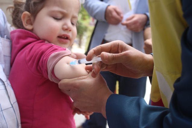 On 25 April 2016, mobile health teams vaccinate children in Aleppo City, outside a collective shelter for displaced families. The first full nationwide immunization campaign since the start of the five-year conflict in Syria, began on 24 April 2016, at the start of World Immunization Week. The campaign, supported by UNICEF and WHO, aims to reach all children under the age of five years old including those living under siege and in hard-to-reach areas, where routine vaccination is almost non-existent and many children have never received any vaccinations. Access to children in these areas is key to the success of the campaign. After five years of conflict, Syrias national immunization rates have dropped from 90 per cent to 57 per cent, putting the countrys 2.8 million under-five-year-old at risk of life-threatening vaccine preventable diseases. In this campaign, children will be immunized against polio, measles, rubella, pertussis (whooping cough), diphtheria, tetanus, hepatitis B and haemophilus influenza type B. Access for health workers is critical to protect these children from deadly diseases. Vaccination is being provided through fixed health centres, outreach activities and mobile teams where required.